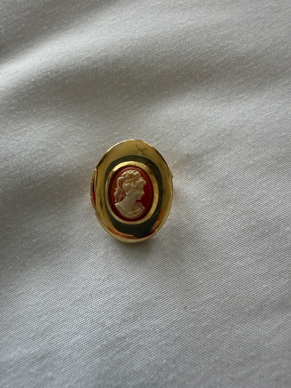 Gold Cameo Statement locket pin with orange Enamel holding